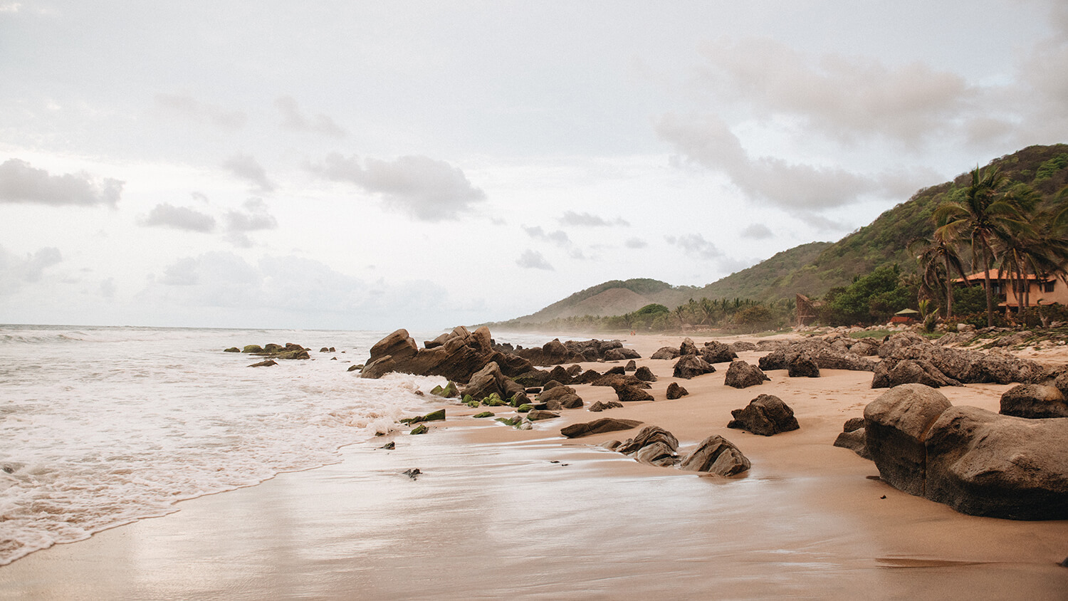 Playa troncones with mountains in background