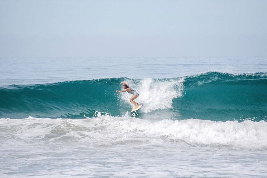 Surfing woman in Mexico
